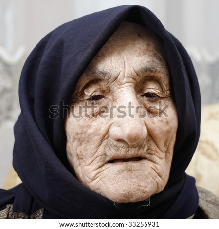 Senior woman face covered with wrinkles portrait