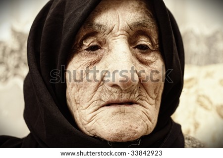 Elderly woman face covered with wrinkles portrait