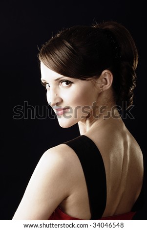 Young woman\'s gaze over shoulder photo over dark