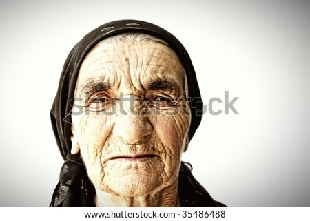 Senior woman face covered with wrinkles portrait