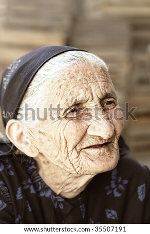 Pensive senior woman looking aside outdoor portrait