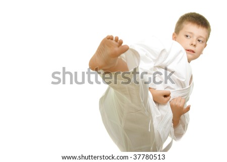 Karate boy making kick photo against white background with copy-space