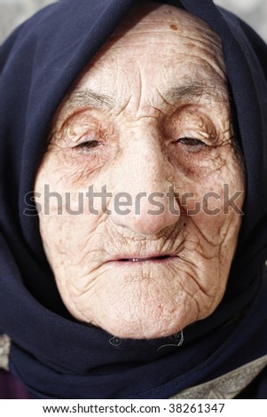 Old woman lost in thoughts closeup face portrait