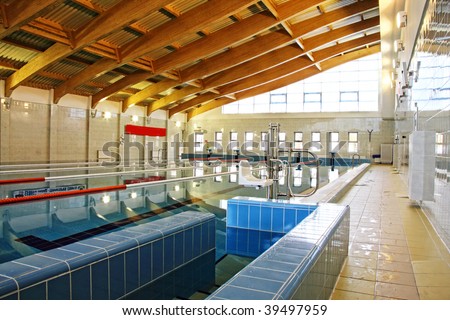Swimming pool with wooden roof beams interior photo
