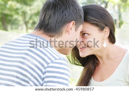 Young pretty couple looking each other eyes with smile