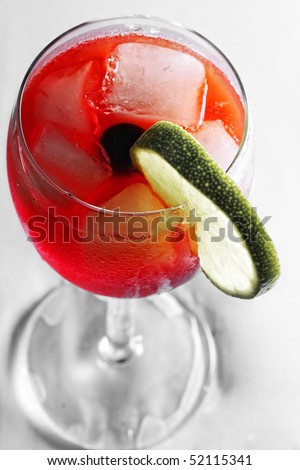 Red cocktail dressed with slice of lime above view