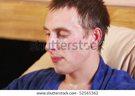 Guy in blue dripping with sweat closeup photo