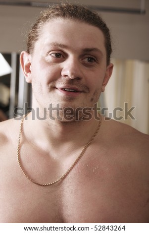Strong guy with gold chain looking sideways closeup photo