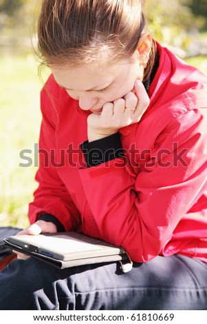 Woman in casual clothes reading electronic book closeup photo