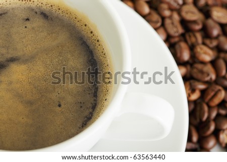 Espresso in white cup and coffee crop selective focus