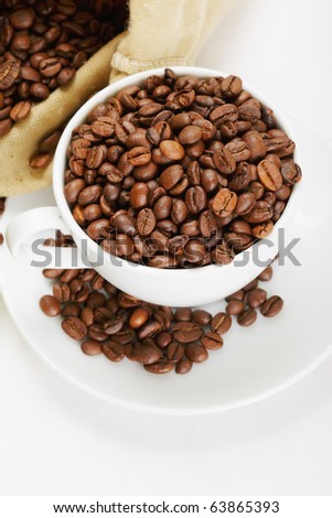 White cup and saucer overfilled with coffee crop