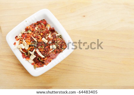 Spice mixture for soup in dish on wooden board above view