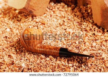 Smoking pipe and wood chips closeup photo