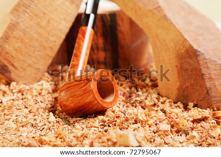Straight briar smoking pipe on wood closeup photo