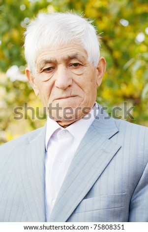 Portrait of serious senior man in formal wear