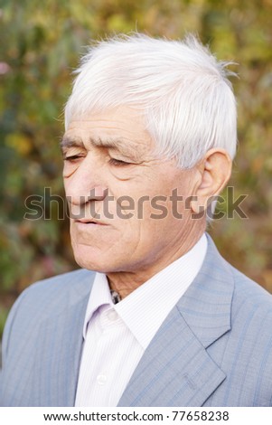 Portrait of pensive senior man in formal wear