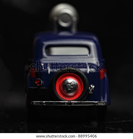 Blue vintage car rear with loudspeaker in darkness