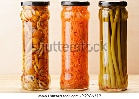 Various canned vegetables on wooden board