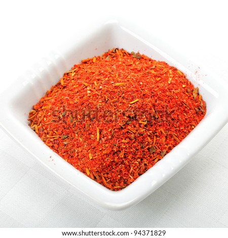 Red spice mixture for fish courses in white ceramic dish