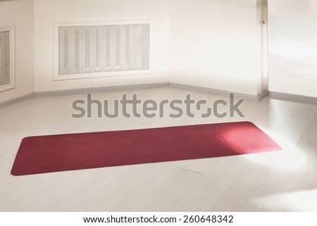 Red mat on an empty gym floor