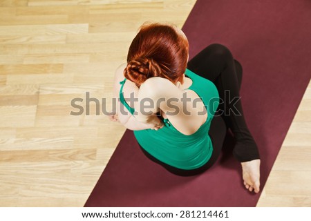 Hand clutched behind back yoga pose high angle view