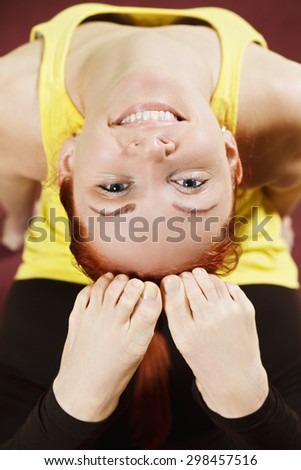 Smiling woman arching her back at yoga exercise closeup photo