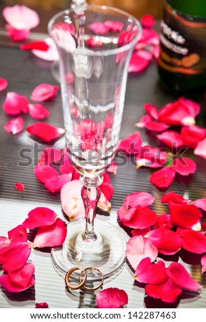 Wedding rings at the base of wine glass