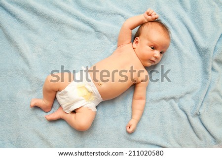 baby lying on a blue blanket