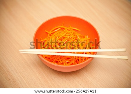 Korean carrots in a bowl with chopsticks, shallow depth of field
