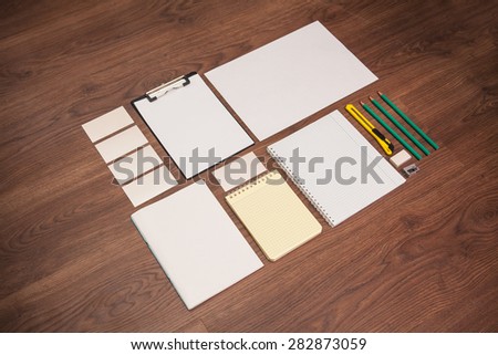 Stationery items on a wooden background.Mock-up for branding identity.