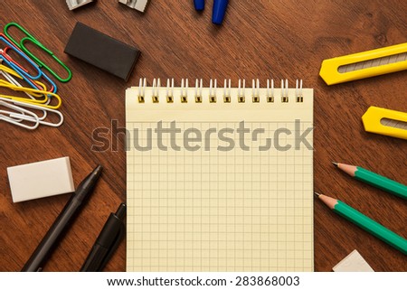 net notebook surrounded by stationery items