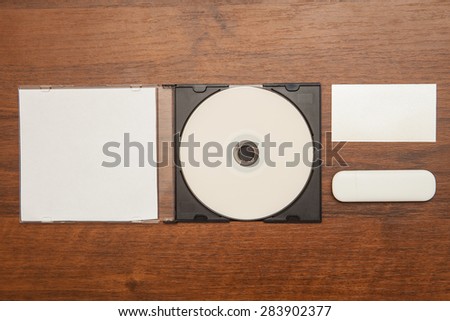 DVD ROM business cards and flash card on a wooden background. Mock-up for branding identity.