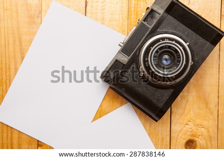 old film camera with a photo on a wooden background