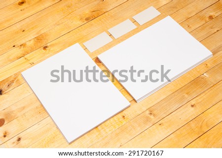 blank forms and business cards on a wooden background. Mock-up for branding identity.