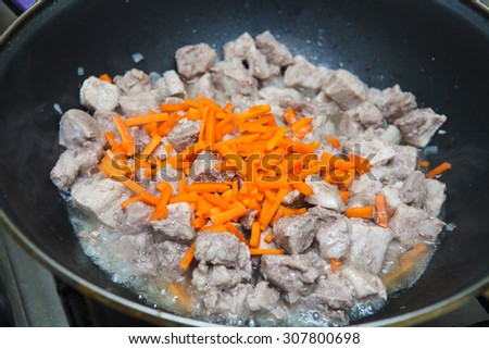pieces of meat with carrots stew pan