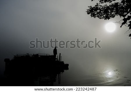 morning fog, sunrise fog over Wisconsin lake with man at dock