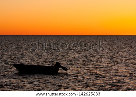 Boat on the ocean at sunset in Shark Bay, Western Australia.