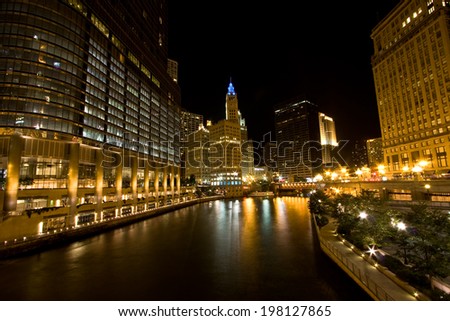 The buildings and architecture of Downtown Chicago at night, by the Chicago River between The Loop and the Magnificent Mile areas.
