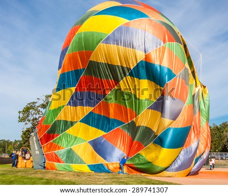 Windsor, CALIFORNIA/UNITED STATES - JUNE 20, 2015: 25th Sonoma County Hot Air Balloon Classic - deflating balloon photographed on June 20, 2015 in Windsor, Keiser Park, in Sonoma Wine Country.
