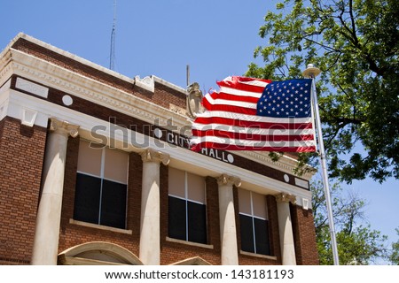Classic City Hall with American flag in Texas.