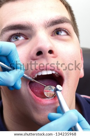 Scared man at a dental clinic, visiting the dentist
