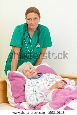 Elderly woman with her caregiver at home