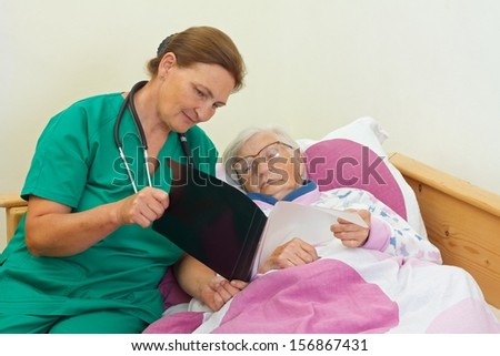 Elderly woman with her caregiver at home