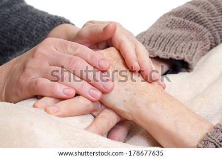 Doctor or nurse holding elderly wrinkled hand