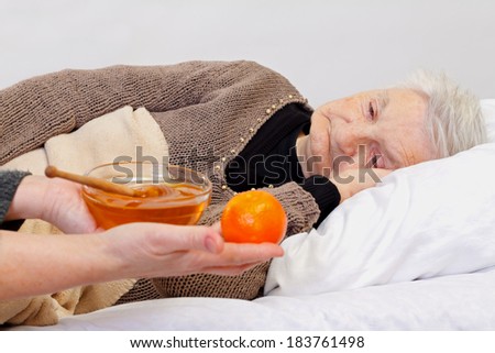 Portrait of an elderly wrinkled woman lying in the bed