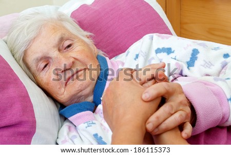 Beautiful elderly woman lying in the bed