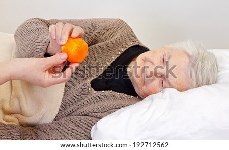 Elderly wrinkled woman laying in the bed