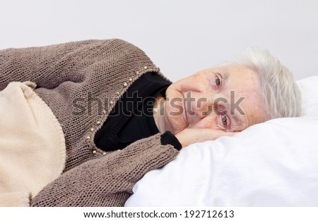 Elderly wrinkled woman laying in the bed