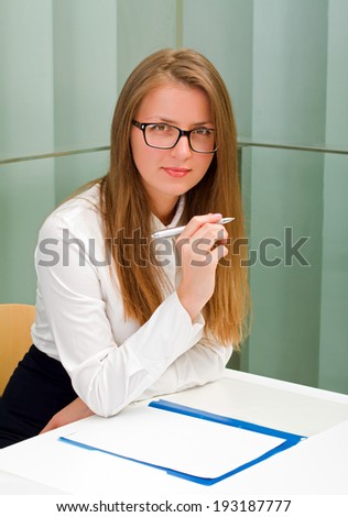 Beautiful secretary woman sitting at her desk