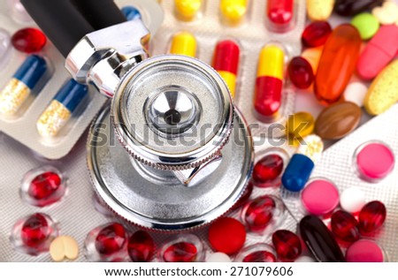 Picture of a colourful pills capsules and stethoscope